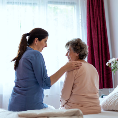 a nurse accompanying elder on bed